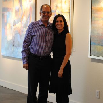 Clark Olson and Christi Bonner Manuelito of Bonner David Galleries, amid works by Max Hammond.
