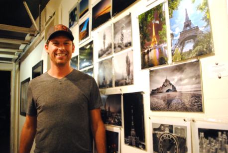 Andrew Pielage runs Drive-Thru Gallery, and here he's in front of several examples of his captivating photography from around the world.