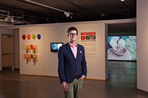 Garth Johnson, the ASU Art Museum curator of ceramics, stands in front of "Welcome Home," with the video "Ghetto is Resourceful," 2014, by Roberto Lugo in the background. Courtesy of the ASU Art Museum; photo by Tom Story.  